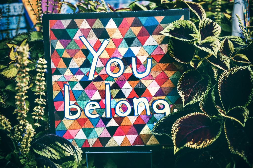 Image shows the words 'You belong' on acolourful background